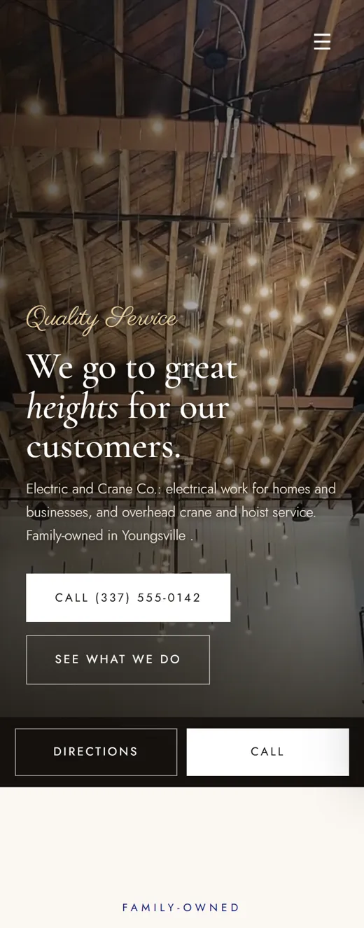 Phone view of a concept site for an electrical and crane contractor: string lights in a high ceiling, call and directions buttons.